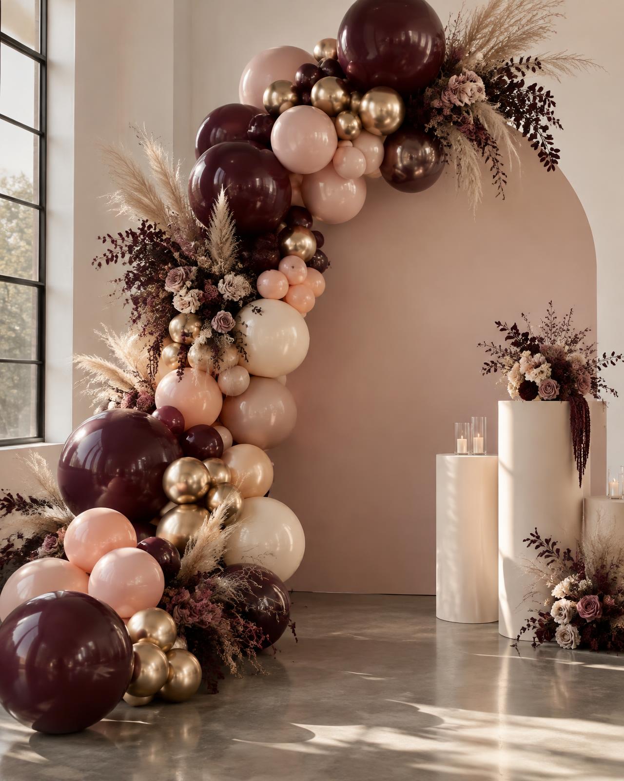 Luxury balloon garland installation in plum, blush and gold
